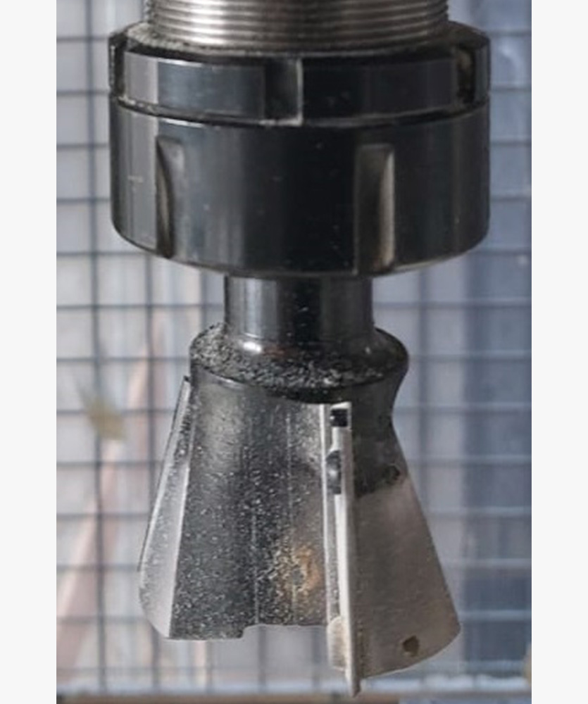 Brown leather key ring with brass metal loops and rivets on wood table.