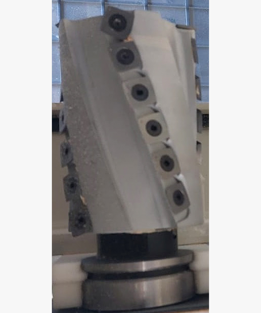 Brown leather key ring with brass metal loops and rivets on wood table.