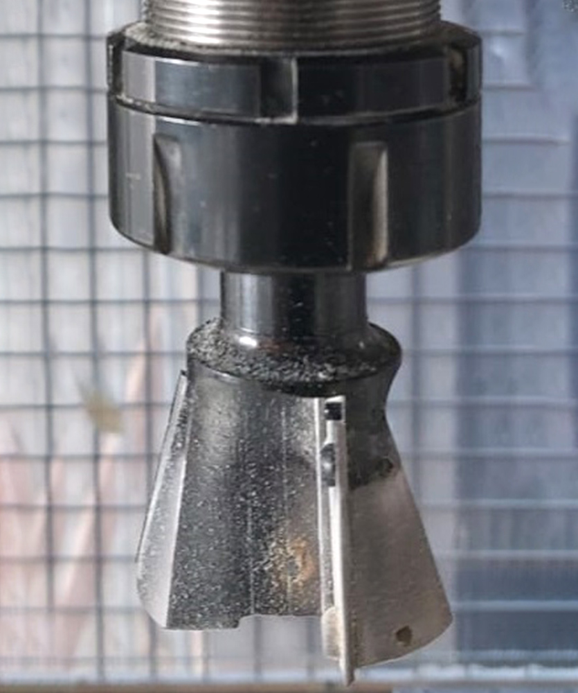 Brown leather key ring with brass metal loops and rivets on wood table.